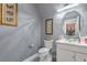 A neutral powder room with a glass bowl sink and decorative framed art at 7537 Splashing Rock Dr, Las Vegas, NV 89131