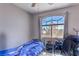 Bedroom showcasing a ceiling fan and a large window providing ample natural light at 7537 Splashing Rock Dr, Las Vegas, NV 89131
