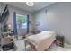Cozy bedroom with a ceiling fan, light gray walls, and a window with natural light at 7537 Splashing Rock Dr, Las Vegas, NV 89131