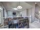 Open-concept dining room next to the living room features a modern table set and plenty of natural light at 7537 Splashing Rock Dr, Las Vegas, NV 89131