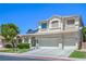 Charming two-story home featuring a three-car garage, landscaped yard, and a tile roof, basking in the bright sunlight at 7537 Splashing Rock Dr, Las Vegas, NV 89131