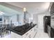 Spacious kitchen island featuring sleek countertops and modern appliances, seamlessly flowing into the dining area at 7537 Splashing Rock Dr, Las Vegas, NV 89131