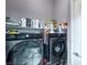 Laundry room with side by side washer and dryer and shelving at 7537 Splashing Rock Dr, Las Vegas, NV 89131
