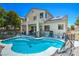 Backyard featuring a refreshing kidney-shaped pool and covered patio, perfect for outdoor entertaining at 7537 Splashing Rock Dr, Las Vegas, NV 89131