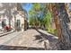 Lush backyard featuring patio, outdoor furniture, and mature trees providing shade and privacy at 8215 Crow Valley Ln, Las Vegas, NV 89113
