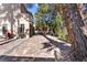 Expansive backyard featuring a custom brick patio and beautiful mature trees offering ample shade at 8215 Crow Valley Ln, Las Vegas, NV 89113