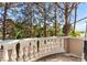Home balcony showcases verdant tree views and a decorative white concrete railing at 8215 Crow Valley Ln, Las Vegas, NV 89113