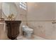 Powder bathroom featuring a stone countertop, gold fixtures, and decorative mirror at 8215 Crow Valley Ln, Las Vegas, NV 89113
