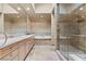 Luxury bathroom featuring double sinks, marble accents, a bathtub, and a walk-in shower at 8215 Crow Valley Ln, Las Vegas, NV 89113
