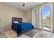 Modern bedroom with sliding glass door to balcony, contemporary rug, and marble flooring at 8215 Crow Valley Ln, Las Vegas, NV 89113