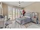 Bright bedroom featuring shuttered glass doors, silver furniture set and marble flooring at 8215 Crow Valley Ln, Las Vegas, NV 89113