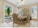 Cozy dining area with a round table, elegant chairs, and sliding door access to the outdoors at 8215 Crow Valley Ln, Las Vegas, NV 89113