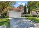 Beautiful two-story home with a garage, driveway, and well-manicured landscaping at 8215 Crow Valley Ln, Las Vegas, NV 89113