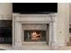 Living room fireplace with marble surround and mantle, and a flat screen TV above at 8215 Crow Valley Ln, Las Vegas, NV 89113