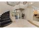 Grand foyer with a spiral staircase, marble floors, and high ceilings at 8215 Crow Valley Ln, Las Vegas, NV 89113