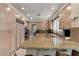 Well-lit kitchen with granite counters, stainless appliances, and ample cabinet space at 8215 Crow Valley Ln, Las Vegas, NV 89113