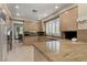 Bright kitchen with granite countertops, modern appliances, and a view into the dining area at 8215 Crow Valley Ln, Las Vegas, NV 89113