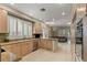 Gourmet kitchen with stainless steel appliances, granite countertops, and ample natural light at 8215 Crow Valley Ln, Las Vegas, NV 89113