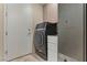 Laundry room with washer, dryer, sink, cabinets and door to the outside at 8215 Crow Valley Ln, Las Vegas, NV 89113