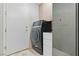 Laundry room with new appliances, tiled floor and utility sink at 8215 Crow Valley Ln, Las Vegas, NV 89113
