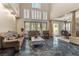 Elegant living room with high ceilings, large windows, and sophisticated furnishings at 8215 Crow Valley Ln, Las Vegas, NV 89113