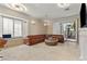 Comfortable living room with large windows, a stylish fireplace, and plush seating at 8215 Crow Valley Ln, Las Vegas, NV 89113