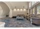 Bright living room featuring unique blue-marble floors, soaring ceilings, and a curved staircase at 8215 Crow Valley Ln, Las Vegas, NV 89113
