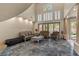 Elegant living room with high ceilings, marble floors, and ample natural light at 8215 Crow Valley Ln, Las Vegas, NV 89113