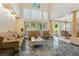 Spacious living area with a view to the dining room, accentuated by tall windows and tasteful decor at 8215 Crow Valley Ln, Las Vegas, NV 89113