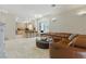 Open concept floor plan showing the living room with comfortable leather furniture and access to the kitchen at 8215 Crow Valley Ln, Las Vegas, NV 89113