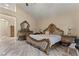 Main bedroom featuring a large bed, marble floors, and decorative lamps at 8215 Crow Valley Ln, Las Vegas, NV 89113