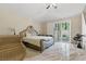 Main bedroom with ornate furniture, shiny tile flooring, and sliding glass doors at 8215 Crow Valley Ln, Las Vegas, NV 89113
