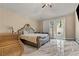 Main bedroom featuring a large bed, marble floors, and access to the backyard at 8215 Crow Valley Ln, Las Vegas, NV 89113