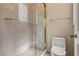 Contemporary bathroom featuring a glass shower, modern fixtures, and tiled walls at 8215 Crow Valley Ln, Las Vegas, NV 89113