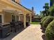 Large backyard with covered patio, barbecue area, lush greenery, and stone paved walkway at 8225 Bermuda Beach Dr, Las Vegas, NV 89128