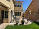 Charming backyard with a seating area, green lawn, potted plants, and a perimeter block wall at 8225 Bermuda Beach Dr, Las Vegas, NV 89128