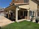 Expansive backyard featuring a covered patio area ideal for entertaining with lush landscape at 8225 Bermuda Beach Dr, Las Vegas, NV 89128