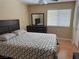 Bedroom with a ceiling fan, big window, and a dresser with a dark wood finish at 8225 Bermuda Beach Dr, Las Vegas, NV 89128