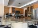 Updated kitchen featuring granite counters, stainless steel appliances and wooden cabinets at 8225 Bermuda Beach Dr, Las Vegas, NV 89128