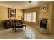Elegant living room featuring a fireplace, tile floors, and plantation shutters for natural light control at 8225 Bermuda Beach Dr, Las Vegas, NV 89128