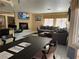 Open-concept living area with a fireplace, comfortable seating, and a view into the dining space at 8225 Bermuda Beach Dr, Las Vegas, NV 89128