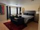 Main bedroom with ample natural light from windows and black curtains, creating a relaxing retreat at 8225 Bermuda Beach Dr, Las Vegas, NV 89128