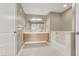 Luxurious bathroom featuring a dual vanity, soaking tub, and linen closet at 8255 Las Vegas Blvd # 1422, Las Vegas, NV 89123