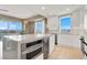 Bright, modern kitchen features an island, stone countertops, and stainless steel appliances with mountain views at 8255 Las Vegas Blvd # 1422, Las Vegas, NV 89123