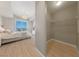 Open-concept bedroom view featuring hardwood floors, walk-in closet and balcony at 8255 Las Vegas Blvd # 809, Las Vegas, NV 89123