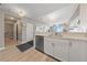 Bright kitchen area with white cabinets, a stainless steel dishwasher and light wood flooring throughout at 8255 Las Vegas Blvd # 809, Las Vegas, NV 89123