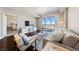Bright living room featuring hardwood floors, modern furnishings, and sliding glass doors with mountain views at 8255 Las Vegas Blvd # 809, Las Vegas, NV 89123