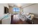 Bright and airy living room featuring hardwood floors and access to a private balcony with mountain views at 8255 Las Vegas Blvd # 809, Las Vegas, NV 89123