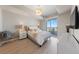 Bright main bedroom with bedside tables, balcony and decorative chandelier at 8255 Las Vegas Blvd # 809, Las Vegas, NV 89123