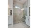 Bathroom featuring a glass shower with marble-style tiling and a built-in bench at 827 Klamath Springs St, Henderson, NV 89011